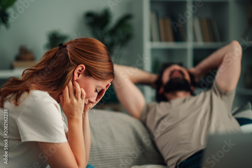 Fotografie Couple having relationship problems at home, woman crying, man showing indiffere