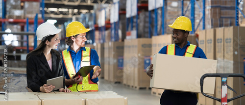 Storage warehouse area. Warehouse worker or teamwork. Male and female warehouse workers discuss about work at warehouse