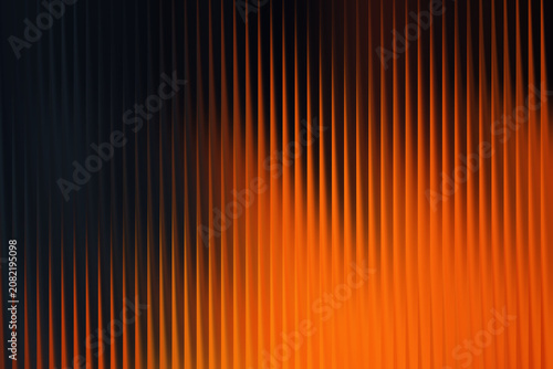 Abstract orange vertical lines background, glowing amber light streaks on dark backdrop, vibrant motion blur texture for digital design