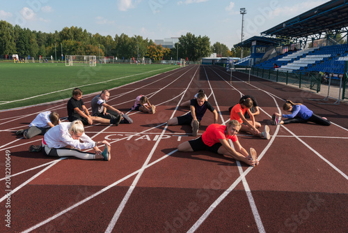 Group of children conducts a training session at the stadium. School gym trainings or athletics