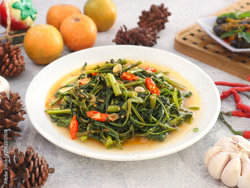 Obraz na plátně Traditional Indonesian dish cah kangkung—stir‑fried water spinach (morning glory) cooked with garlic, onion, and chili peppers