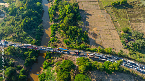 Fotografie Surrounded by agricultural fields and lush green forest, the accident scene highlights the importance of this key river crossing route connecting local communities