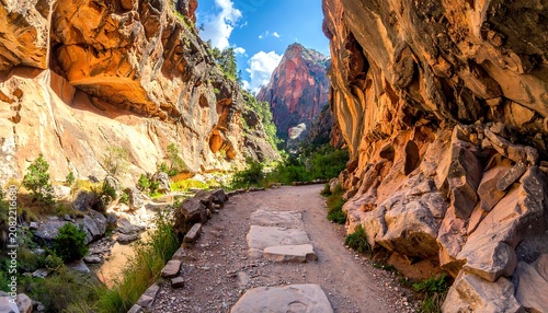 A serene hiking trail nestled between towering orange rock formations
