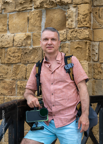 Male tourist enjoying walk through historic streets of Paphos, Cyprus. Mediterranean destination, sightseeing, cultural tourism and leisure travel concept.