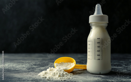 bottle of baby milk on dark grey table
