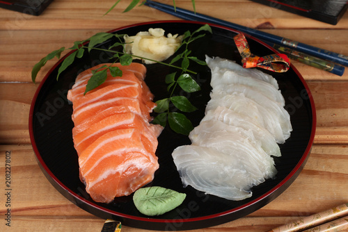 fresh sashimi and sushi served with soy sauce and wasabi