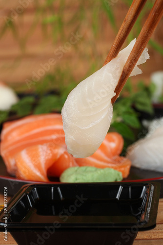 fresh sashimi and sushi served with soy sauce and wasabi