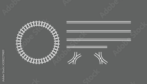 Schematic white line drawing of railway tracks including a circular loop and straight line switches on grey.