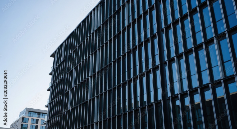 Fototapeta premium Modern Glass Facade Office Building Under Clear Sky
