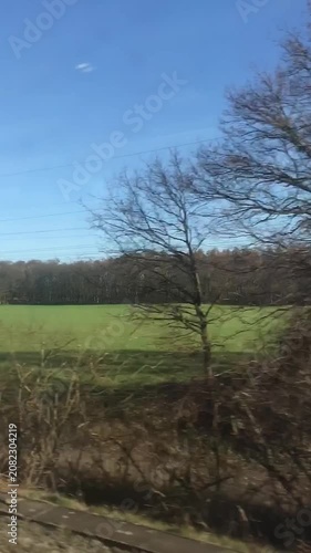 Train Journey Through Countryside with Passing Trees and Fields