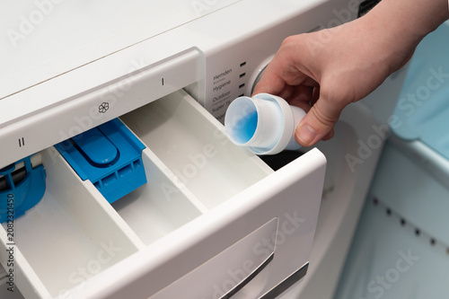 Εκτύπωση καμβά Pouring washing machine protection liquid into the detergent drawer to reduce limescale buildup and help protect internal components during regular laundry cycles