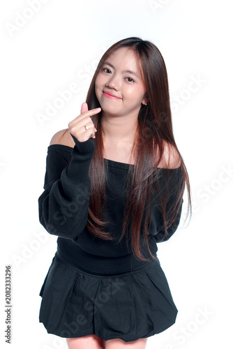 Smiling Young Asian Woman Showing a Finger Heart