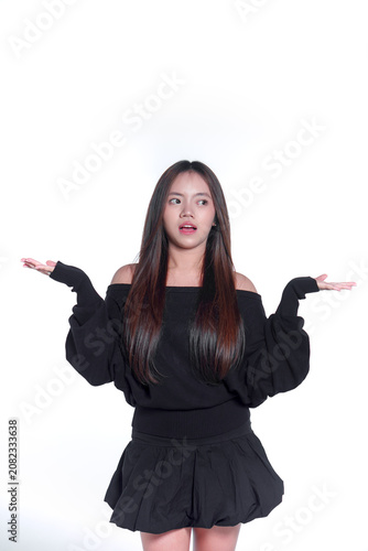 Portrait of a confused young Asian woman shrugging with her hands up