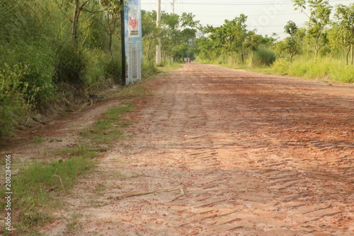 Close up of an unpaved rural road with red soil countryside environment destination