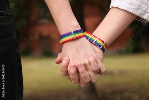 Photos LGBT. People holding hands together outdoors, closeup