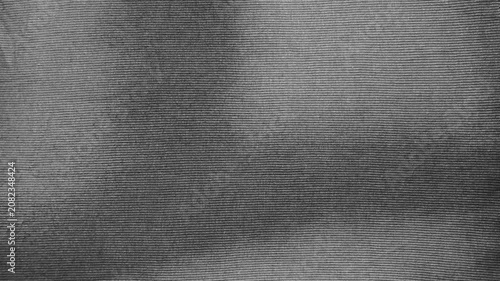 dark grey ribbed cotton fabric macro background showing realistic soft textile texture with organic shadows