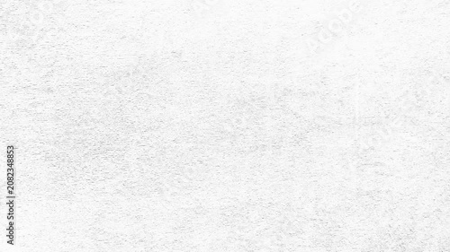 minimalist white textured wall under bright cinematic studio light creating a subtle abstract background
