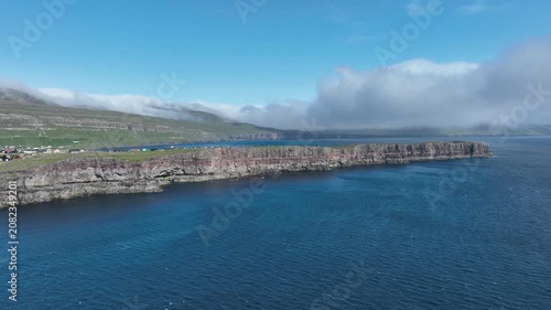 Drone shot of cliff edge on sunny day on the Faroe Islands