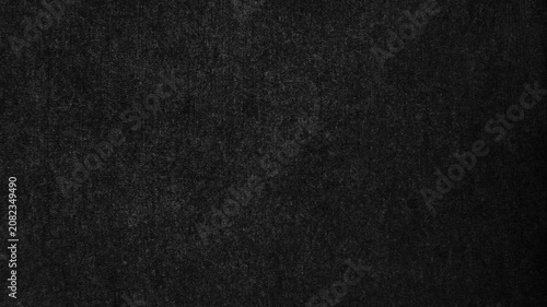 dark black canvas fabric texture ripples gently revealing subtle woven details in a cinematic moody backdrop