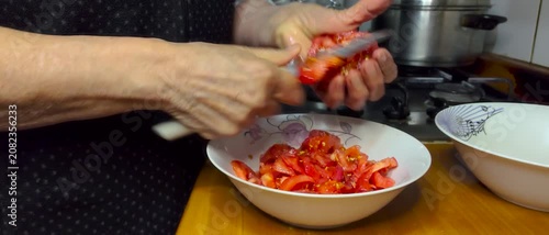 Close Up of Hands Peeling Fresh Ripe Red Tomatoes with Paring Knife Over Bowl During Home Kitchen Food and Meal Preparation for Homemade Healthy Cooking