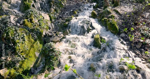 Cascading refreshing waterfall in sunny forest