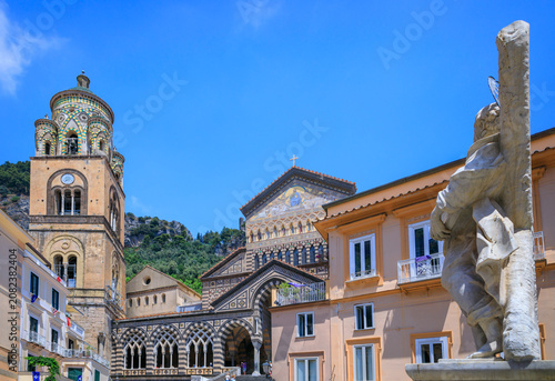 Glimpse of Amalfi Cathedral and the statue of the Apostle St. Andrew from the Piazza del Duomo in southern Italy.