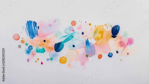 Abstract composition of vibrant watercolor paint splashes and ink droplets blending on clean white surface to create playful artistic expression of color harmony