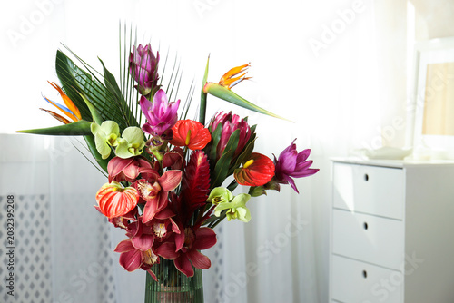 Bouquet of beautiful tropical flowers in vase indoors, closeup. Space for text