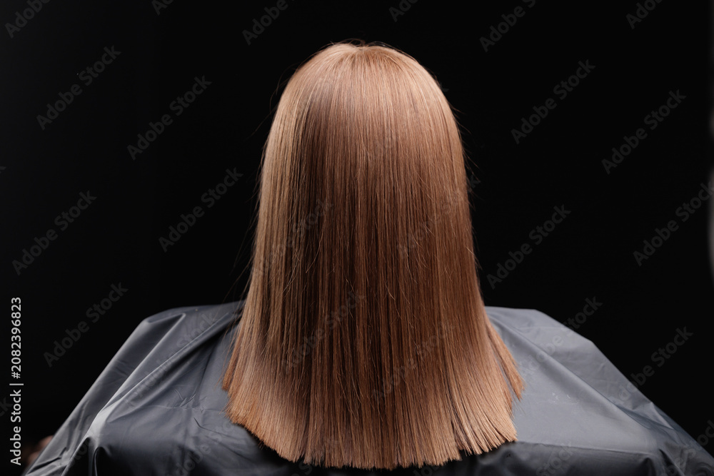 Obraz premium Female haircare keratin treatment result on straight brown hair