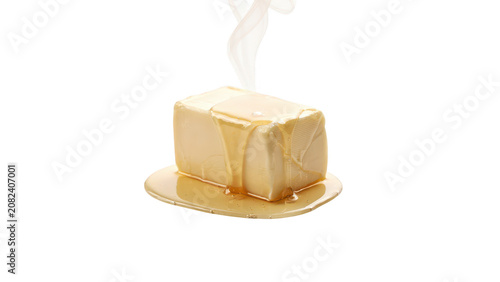 A rectangular stick of yellow butter with melted butter dripping down the sides and pooling on the surface against a solid black background