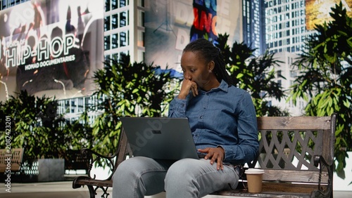 Obraz na płótnie Upset digital nomad girl struggling to work on laptop in the park, barely meeting deadlines, Worried remote worker doing freelancing outside, using notebook and feeling burnout, bad news