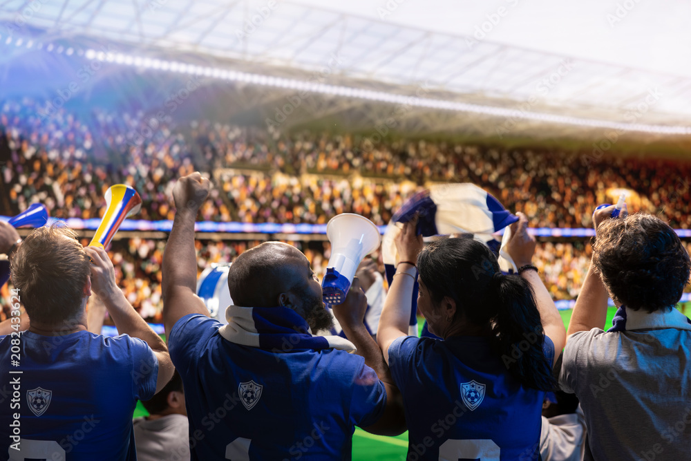 Obraz premium Football supporters in stadium cheering players with megaphone and horns, cheering crowd creates fan chant, using audio equipment to create loud team support.