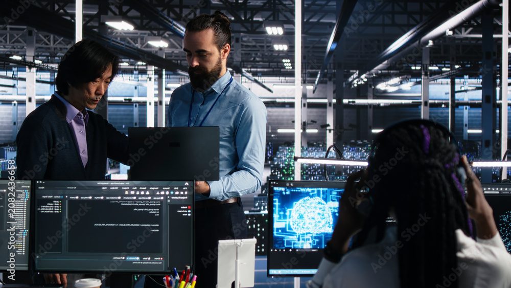 Fototapeta premium Team of server room engineers working with machine learning models to review extensive data sets.