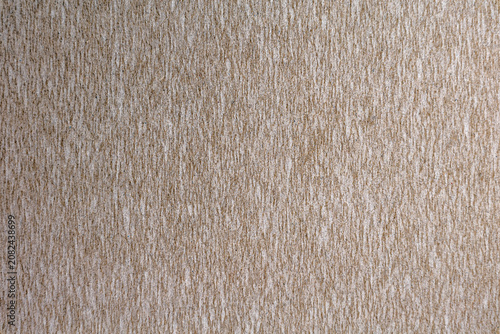 Beige textured wallpaper surface with vertical streaks natural fabric pattern