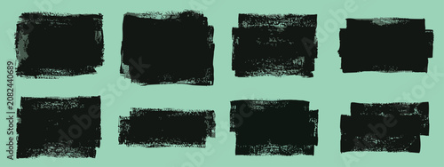 Slika na platnu Set of eight black textured paint stroke squares and rectangles on a light green