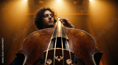Close up of cello instrument with musician performing