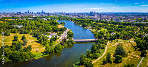 Hyde Park Serpentine aerial view with London skyline in summer sunlight