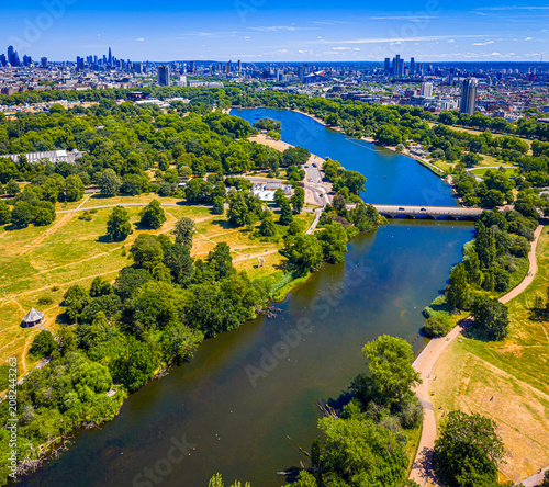 Hyde Park Serpentine aerial view with London skyline in summer sunlight