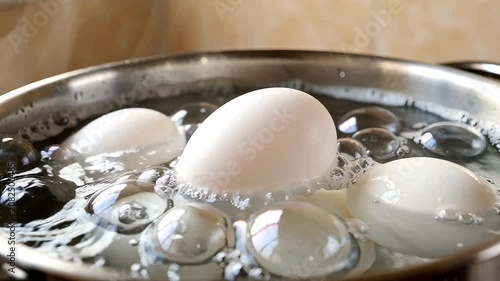 White chicken eggs boiling in water