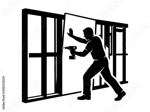 Construction worker installing wall panel with drill.