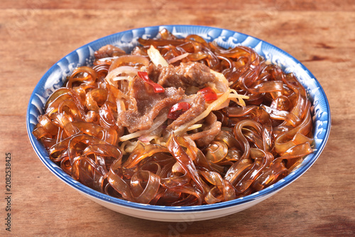 cantonese-styles stir-fried beef wideglass noodles on the plate