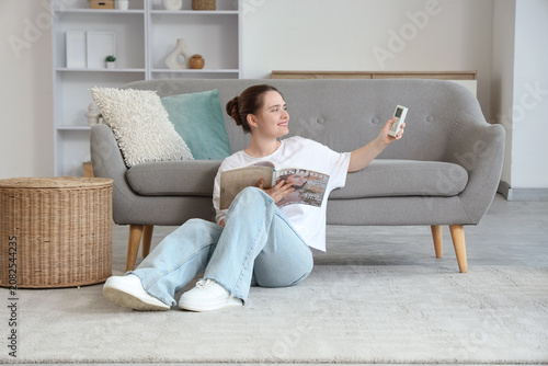Young woman sitting on floo...