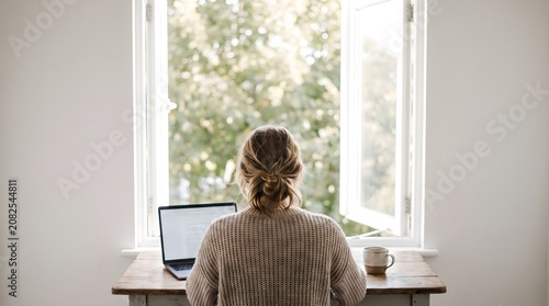 Woman From Behind Typing On Laptop By Open Window