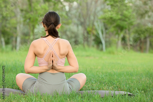 Woman practicing yoga with ...