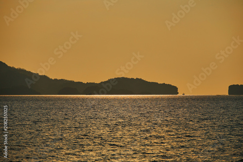 Serene Seascape with Island Coastline at Sunset