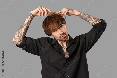 Young tattooed barber combi...