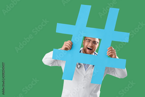 Male doctor with hashtag on...