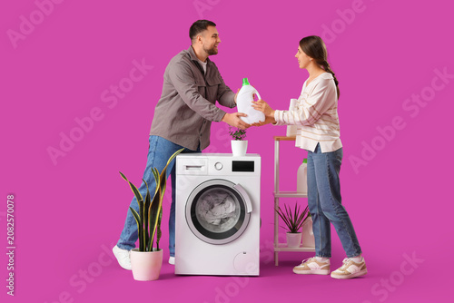 Young couple doing laundry ...