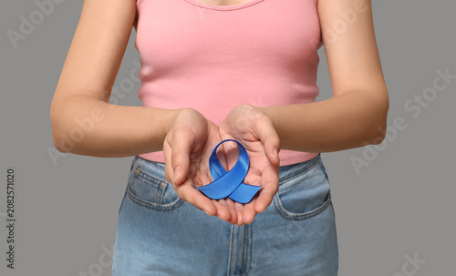 Woman with blue ribbon on g...
