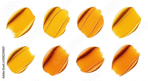 close-up of eight yellow and orange paint strokes on a white background useful for design cosmetics and artistic purposes
